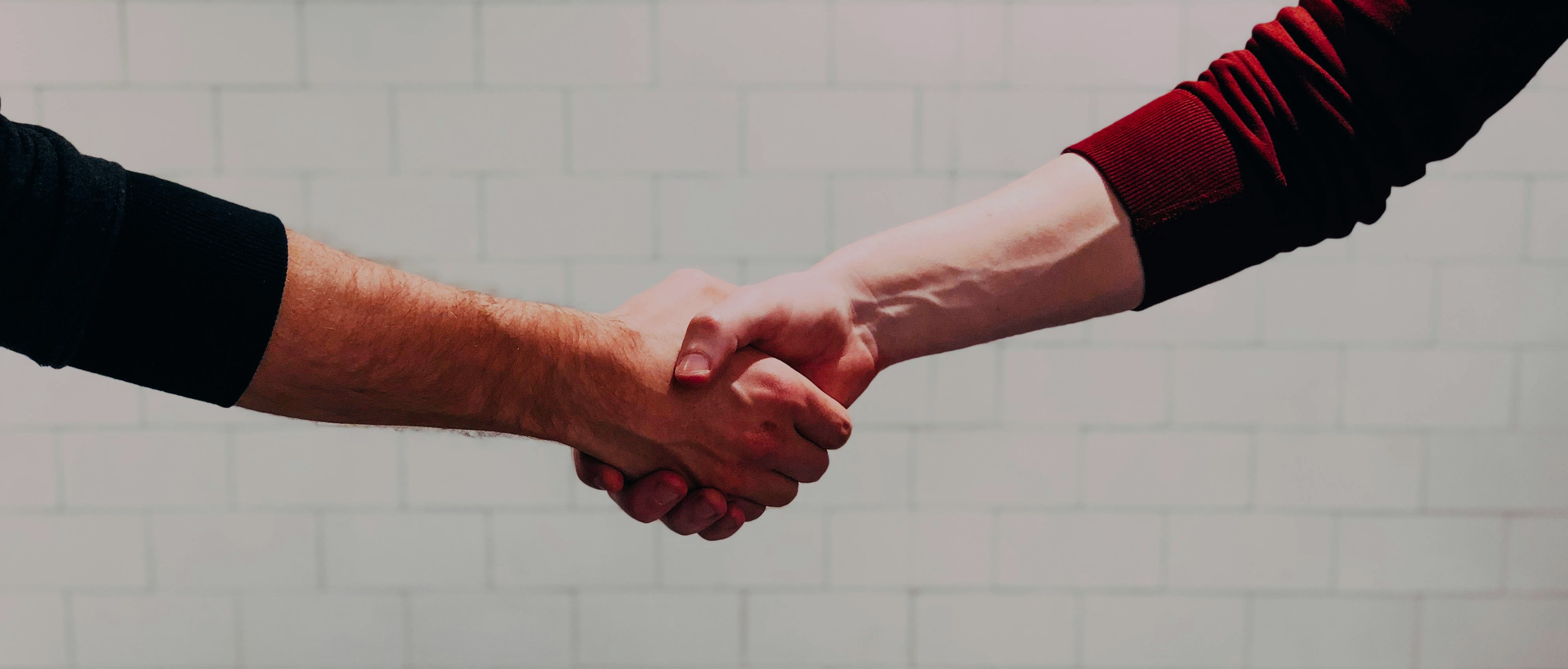 Handshake representing partnership and trust with Toledo Property Rehab